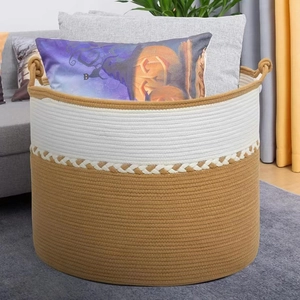 Woven cotton rope laundry basket with dual-tone design and sturdy handles for storage