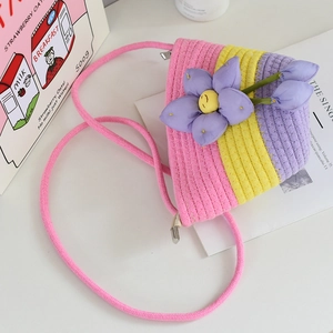 Close-up of woven cotton mini bucket bag with 3D purple flower and pink strap details