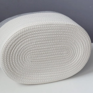 Detailed macro view of the woven cotton rope bottom in a white and gray spliced design