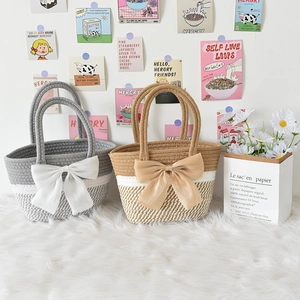 Detailed close-up of woven cotton stripe tote bags with decorative oversized satin bows