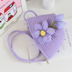 Detailed view of purple woven cotton bucket bag featuring large 3D floral decoration