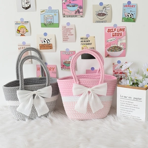 Detail shot of striped cotton rope woven tote bags with large decorative white bows