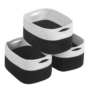 Detailed macro view of set of 3 black and white woven storage baskets with handles