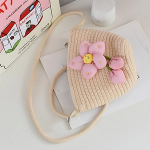 Detailed macro view of woven cotton mini bucket bag with 3D pink floral smiling face decor