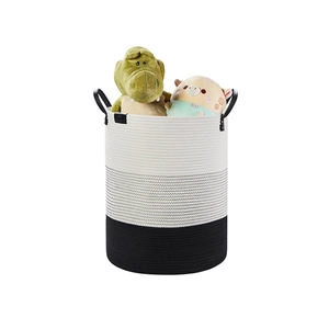 Detail view of a tri-color woven cotton rope storage basket with black leather side handles