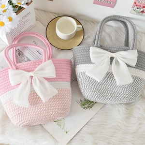 Detailed close-up of woven cotton rope handbags with large decorative silk bows in soft tones