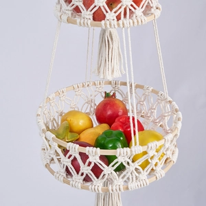 Close-up of Macrame woven tiered hanging fruit basket with cotton cord and tassels