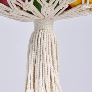 Close-up of handmade bohemian cotton rope knot details and fringe on hanging fruit basket