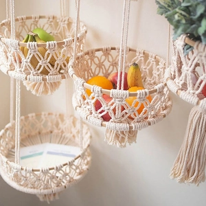Detail of bohemian cotton rope fruit basket with wood rings and elegant tassel fringe