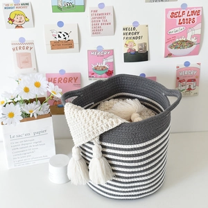 Detailed macro view of woven cotton rope storage basket with gray and white striped pattern
