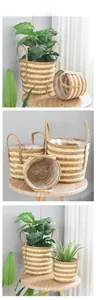 Close-up of Nordic woven straw plant baskets with handles and waterproof liners