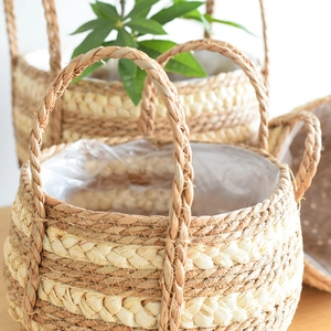 Detail of hand-woven seagrass basket with dual handles and waterproof plastic liner