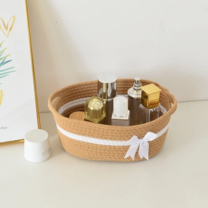 Detailed macro of a hand-woven cotton storage basket with ribbon and cosmetic bottles