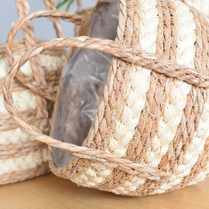 Detail of hand-woven seagrass planter basket with waterproof liner and natural texture