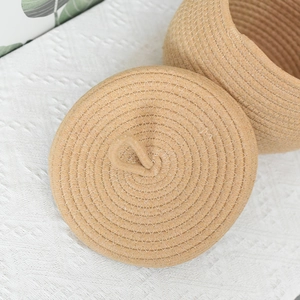 Detailed close-up of handmade round cotton rope storage basket with a circular lid