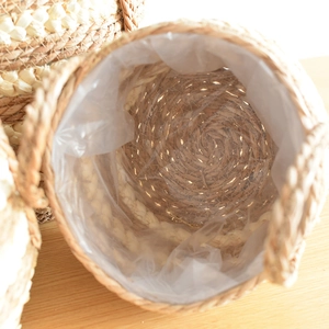 Detail of the waterproof transparent plastic liner inside the woven seagrass planter basket