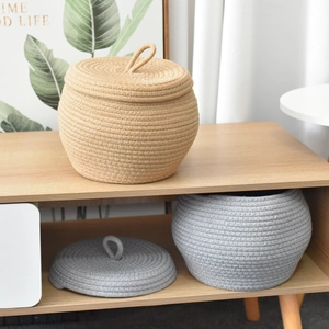 Handwoven pumpkin-shaped cotton rope storage baskets with lids in grey and brown