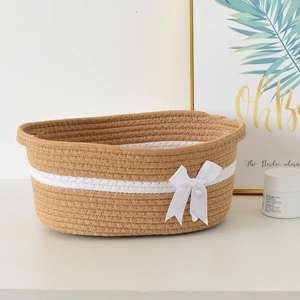 Japanese woven storage basket with white bow decoration for home organization and makeup
