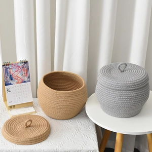 Handwoven cotton rope storage basket with lid in light grey and camel pumpkin shape