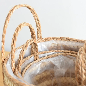 Macro shot of natural woven seagrass planter featuring waterproof liner and curved handles