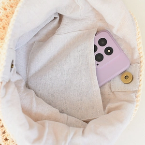 Macro detail of summer woven beach tote bag with linen lining and magnetic buckle