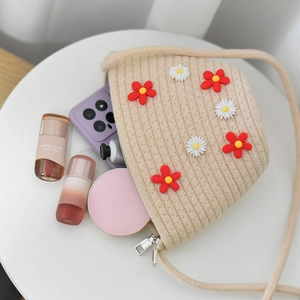 Detailed interior capacity of beige straw woven floral crossbody bag showing daily essentials