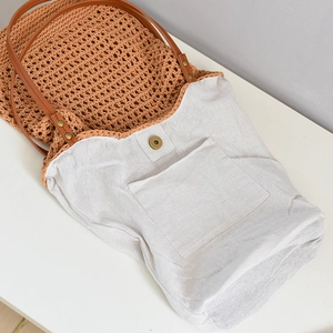 Macro view of woven beach tote showing cotton lining, open pocket and magnetic closure