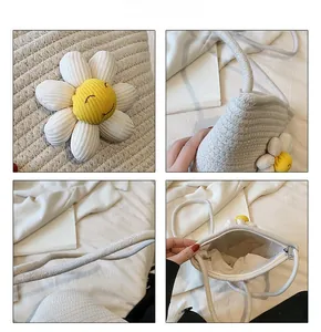 Detail view of woven straw flower bag showing daisy patch, zipper, and textured material
