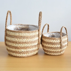 Detail of hand-woven seagrass baskets with dual handles and waterproof plastic liners