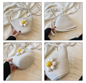 Detail view of woven straw bucket bag with sunflower accent and secure zipper closure