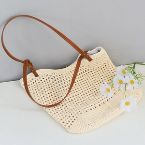 Detail of woven mesh tote bag with beige cotton cord and brown leather shoulder straps