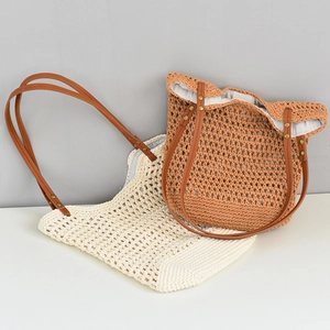 Detail of hand-woven hollow crochet beach tote bags with brown leather shoulder straps
