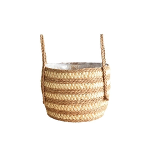 Handwoven Nordic seagrass planter basket with dual handles and plastic liner for indoor plants