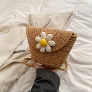Cute woven straw crossbody bag with white daisy smile face for summer beach trips