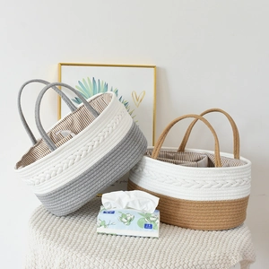 Detail of woven cotton rope baby baskets with striped liners and braided side textures