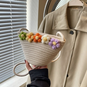 Handmade woven crossbody bag with colorful 3D crochet flowers for beach vacations