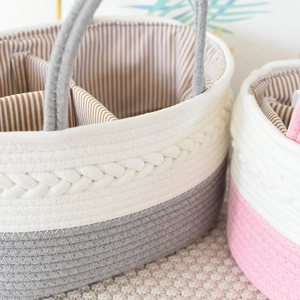 Close-up of woven cotton rope diaper caddy with braided texture and striped lining