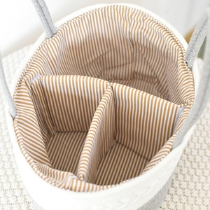 Detailed top view of a woven cotton rope baby organizer basket with three divided compartments