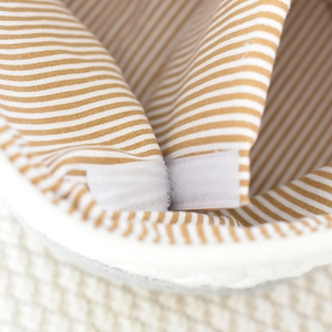 Detailed view of striped cotton lining and hook-and-loop closure inside the baby storage basket