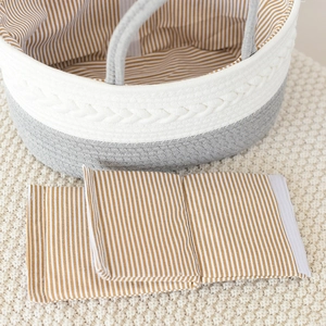 Close-up of dual-tone cotton rope storage basket with striped lining and knit background