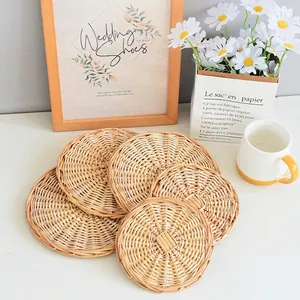 Stack of circular woven heat-resistant table mats in a natural wood finish