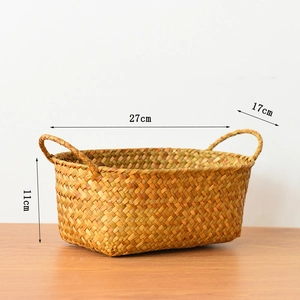 Detail of hand-woven rectangular seagrass basket showing natural fiber texture and side handles