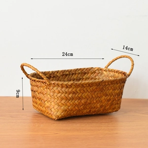 Detail view of a handmade woven storage basket with dual handles and size dimensions