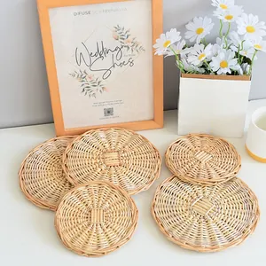 Detail of handwoven round rattan placemats with spiral texture on a white kitchen table