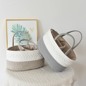 Handwoven cotton rope baby diaper caddy with striped lining and dual handles for nursery storage