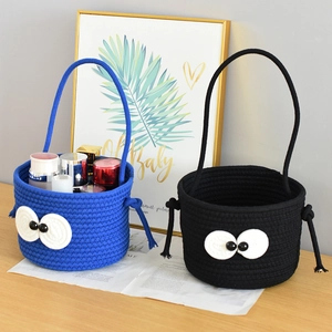 Detail of woven storage baskets with cute big eyes, holding skincare bottles on a desk