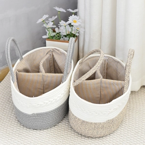 Detail of woven cotton baby basket with three compartments and soft striped lining