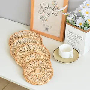 Detail of five handcrafted round woven rattan coasters for heat resistant table protection