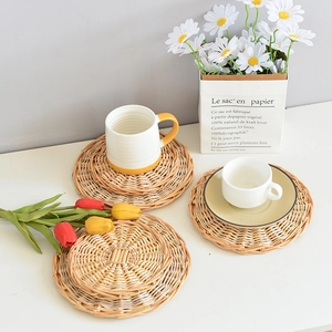 Detail of hand-woven round heat-resistant placemats with a natural spiral wicker texture