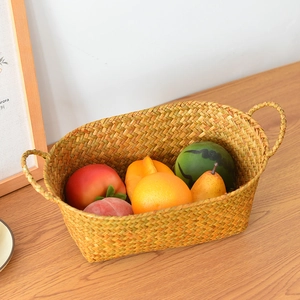 Detailed macro view of a handmade woven fruit basket with sturdy side handles and fruit